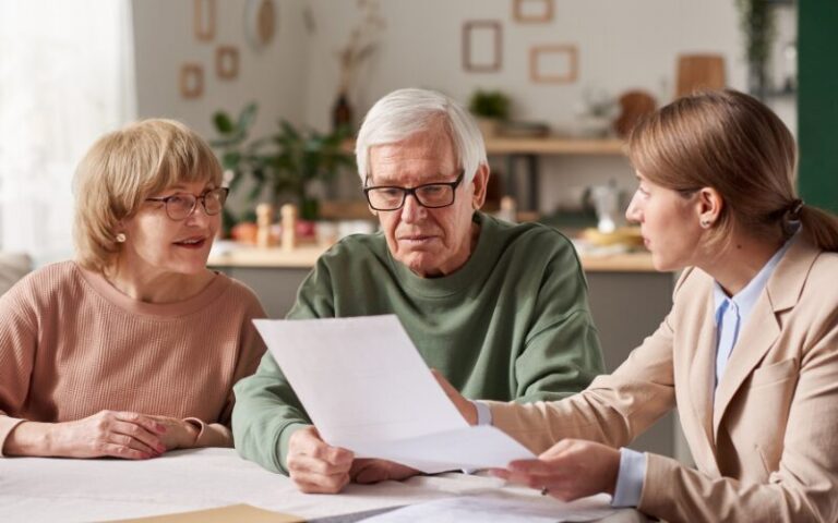 Older couple discussing healthcare directives and living wills with a professional, emphasizing senior care planning and legal documentation.